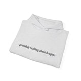 Probably reading about dragons... Hooded Sweatshirt