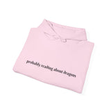 Probably reading about dragons... Hooded Sweatshirt