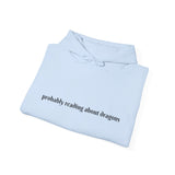 Probably reading about dragons... Hooded Sweatshirt