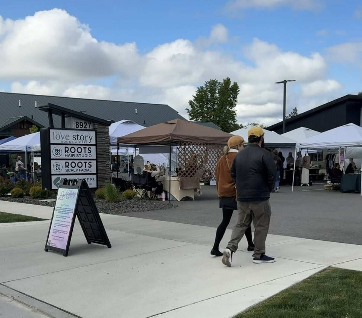 Plot Fest market day: tents in the lot in front of It's a Love Story Books & Café, Hayden, Idaho